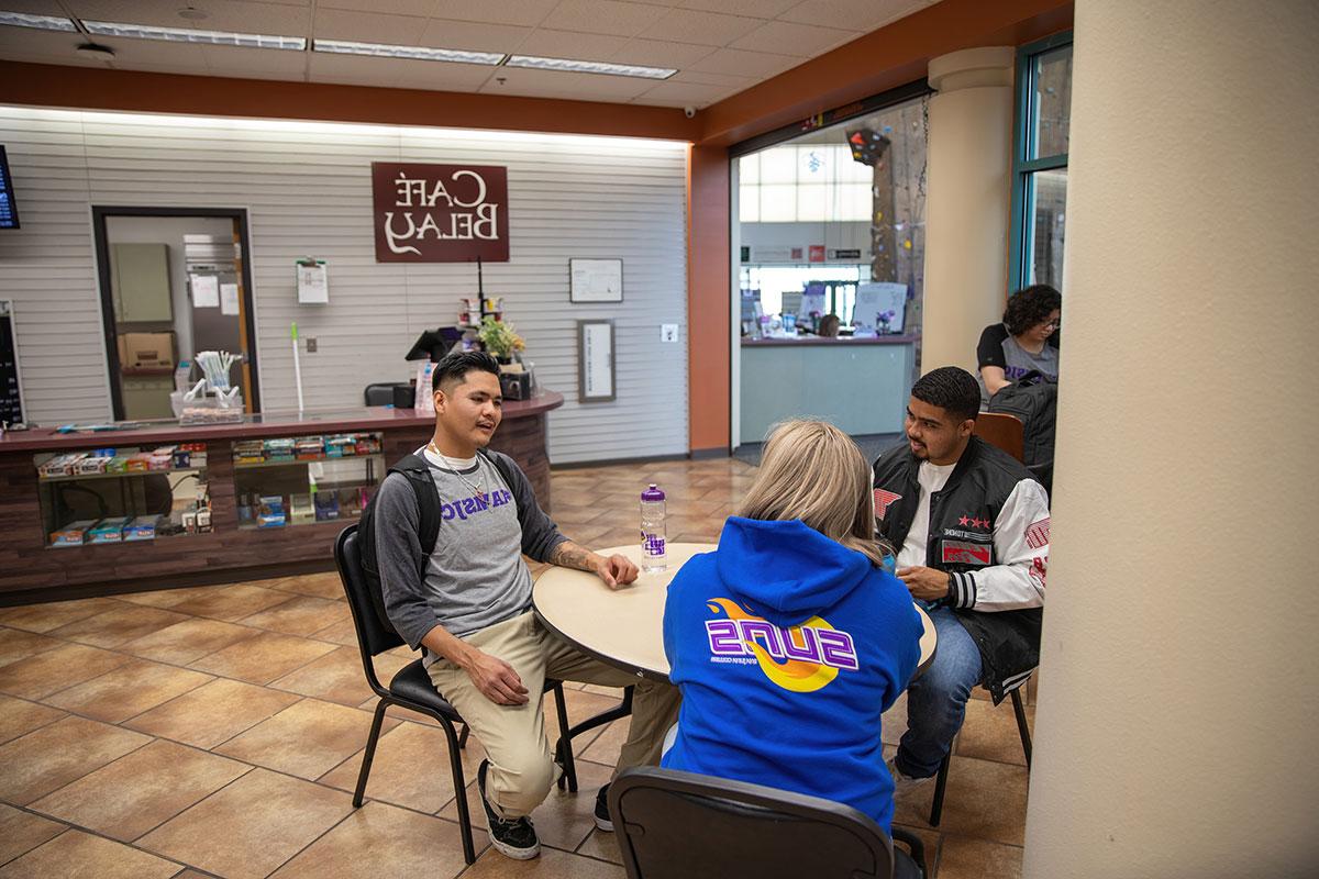 Three students sitting in SJC HHPC Cafe Belay